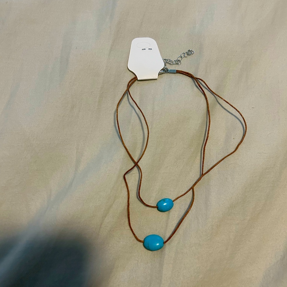 Blue pendant necklace with brown string